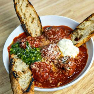 Beef and pork meatballs, tomato sauce, almond pesto, ricotta cream cheese, and grilled baguette slices. **contains tree nuts, egg, wheat, dairy**