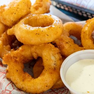 Onion rings with ranch dressing dip. **contains wheat, egg, dairy, soy, may contain fish**