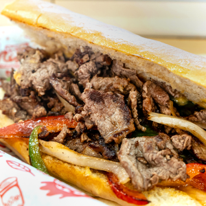 Chopped steak, American cheese, peppers, onions, and jalapeños on a hoagie roll. **contains wheat, dairy, egg**