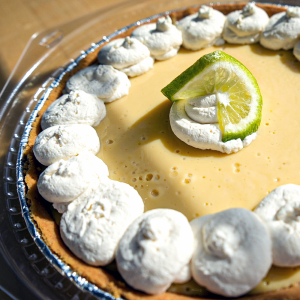 Slice of Key Lime Pie with Whipped Cream. **contains wheat, dairy, egg**