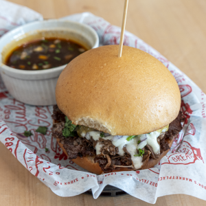 Smash Patty, braised beef, cilantro, onion, mozzarella, and salsa verde served on a brioche bun. Served with a side of consume.