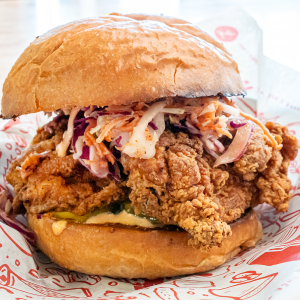 Crispy chicken thigh, charred coleslaw, Calabrian mayonnaise, pickle, and hot honey on a brioche bun. **contains wheat, egg, soy, dairy, may contain fish**