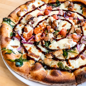 Olive oil, fresh mozzarella cheese, chicken breast, red onion, tomato, feta, garlic, arugula, smoked salt, and balsamic vinegar on a traditional crust. **contains wheat, dairy**