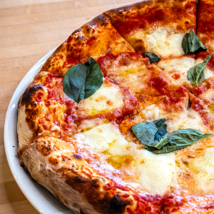 Tomato sauce, fresh mozzarella cheese, olive oil, and basil on a traditional crust. **contains wheat, dairy**