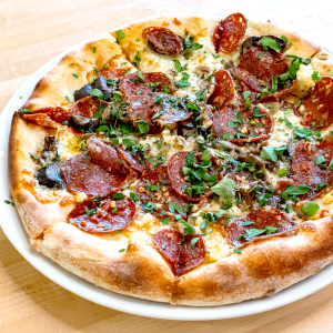 Olive oil, mozzarella cheese, sopressata salami, roasted mushrooms, garlic, goat cheese, parsley, thyme and smoked salt on a traditional crust. **contains wheat, dairy**